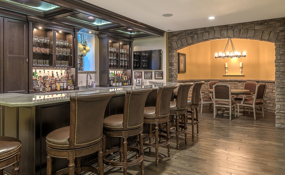 Photo of an expansive traditional home bar in Other with dark hardwood floors and brown floor.