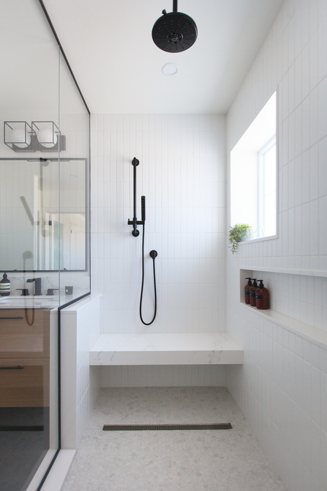 Inspiration for a mid-sized contemporary master bathroom in Toronto with flat-panel cabinets, medium wood cabinets, an alcove shower, a one-piece toilet, white tile, subway tile, white walls, slate floors, an undermount sink, quartzite benchtops, grey floor, a hinged shower door and white benchtops.