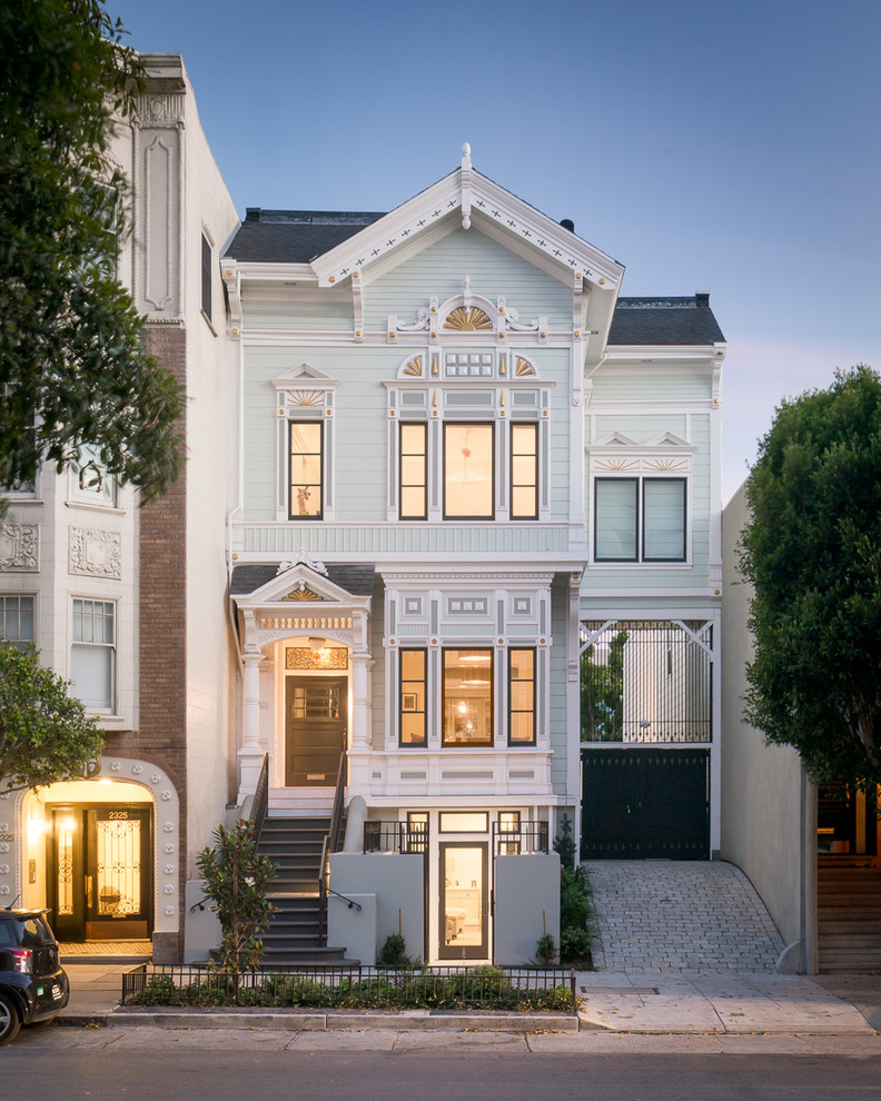 Photo of a traditional three-storey blue exterior in San Francisco with wood siding and a gable roof.