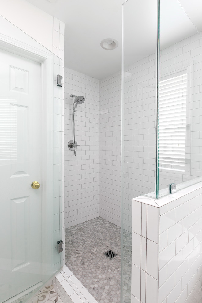 Design ideas for a mid-sized country master bathroom in Charleston with white cabinets, a freestanding tub, white tile, ceramic tile, white walls, cement tiles, an undermount sink, grey floor and a hinged shower door.