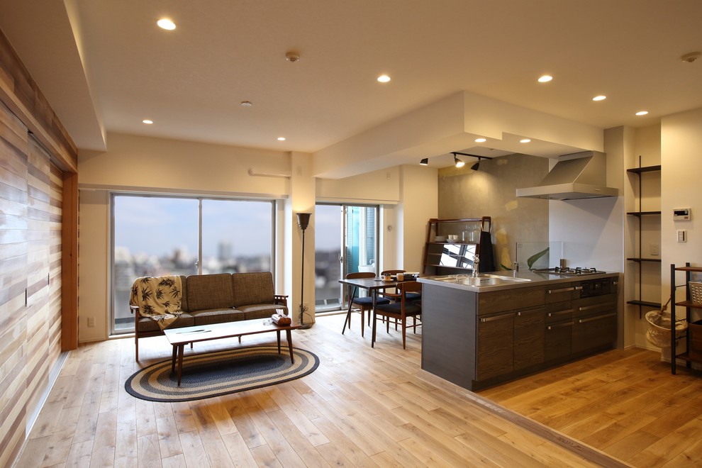 Design ideas for a mid-sized asian living room in Tokyo with medium hardwood floors.