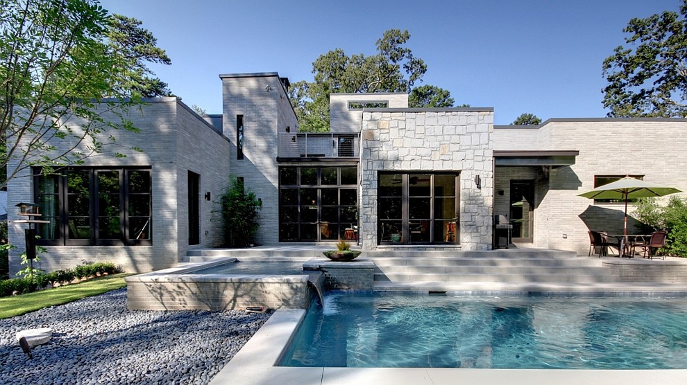 This is an example of a modern exterior in Atlanta with stone veneer.