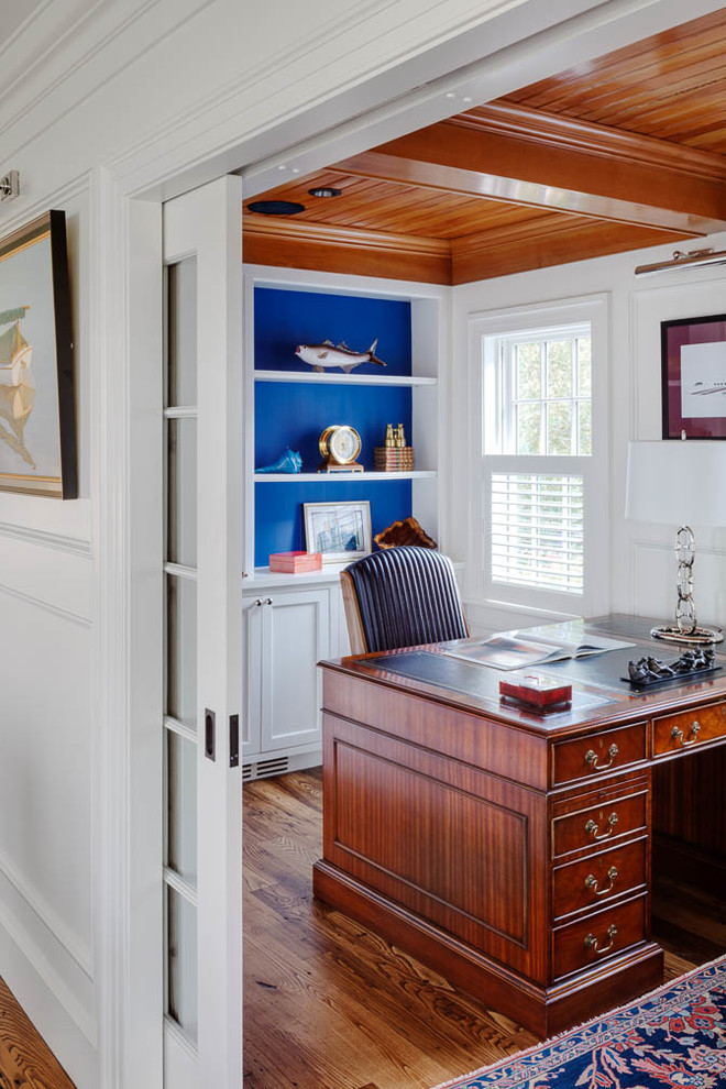 Inspiration for a small beach style study room in Boston with white walls, medium hardwood floors, no fireplace and a freestanding desk.