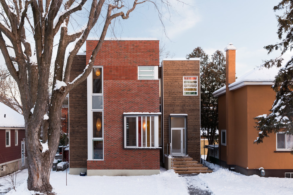 This is an example of a contemporary exterior in Ottawa with wood siding.