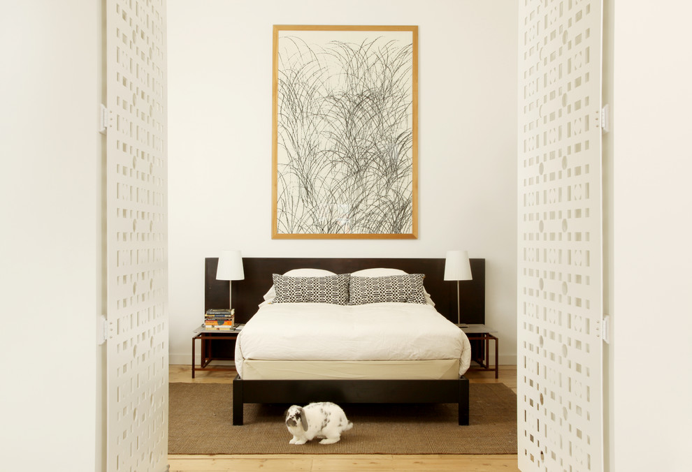 Photo of a contemporary bedroom in Louisville with white walls.