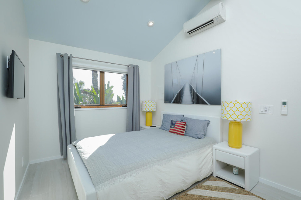 Small beach style bedroom in San Diego with white walls.