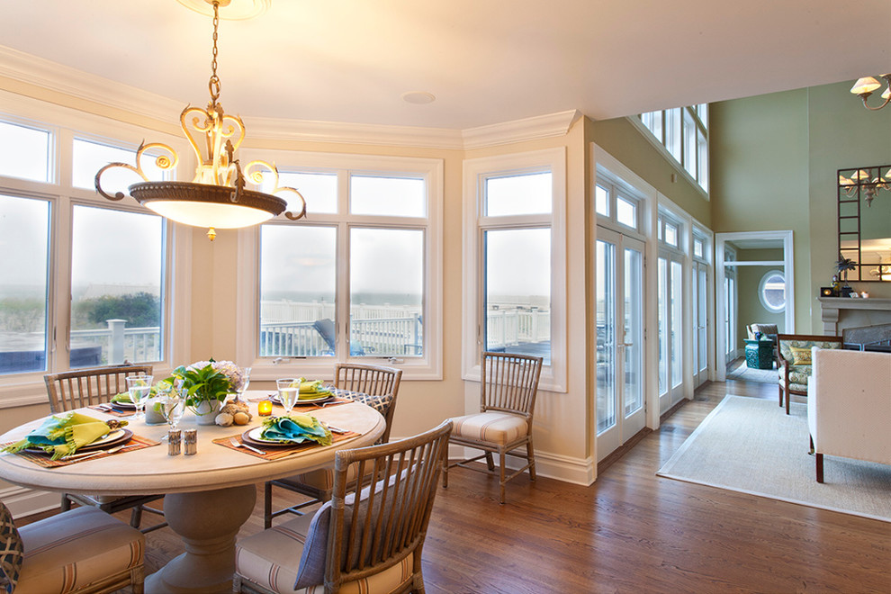 Mid-sized beach style open plan dining in New York with white walls, dark hardwood floors and no fireplace.