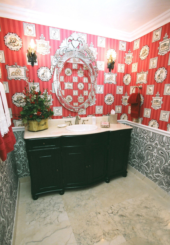 Photo of a mid-sized eclectic powder room in Atlanta with raised-panel cabinets, black cabinets, red walls, a drop-in sink and white floor.