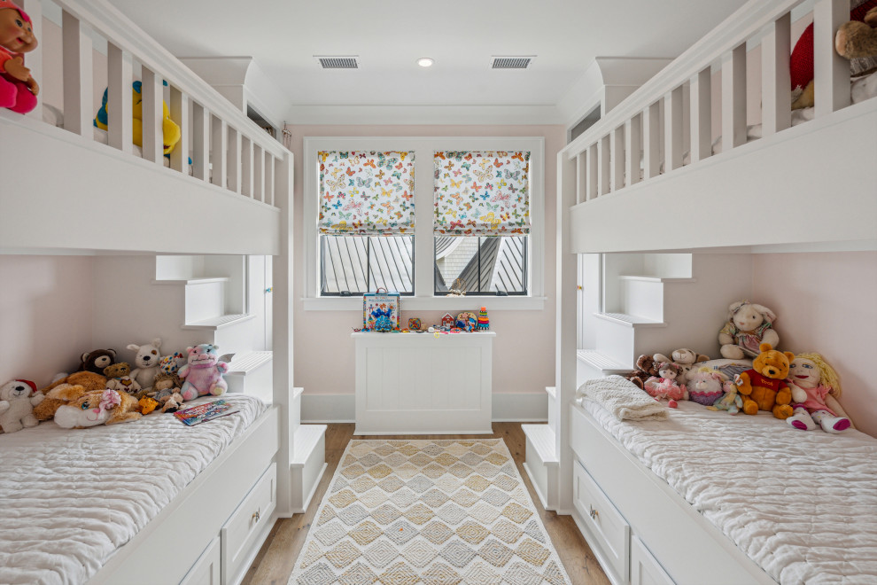 Design ideas for a traditional kids' bedroom in Charleston with pink walls, medium hardwood flooring and brown floors.