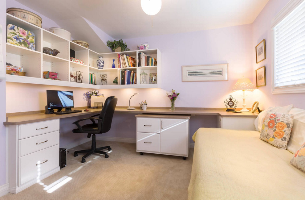 This is an example of a mid-sized transitional home office in Los Angeles with purple walls, carpet, no fireplace, a built-in desk and beige floor.