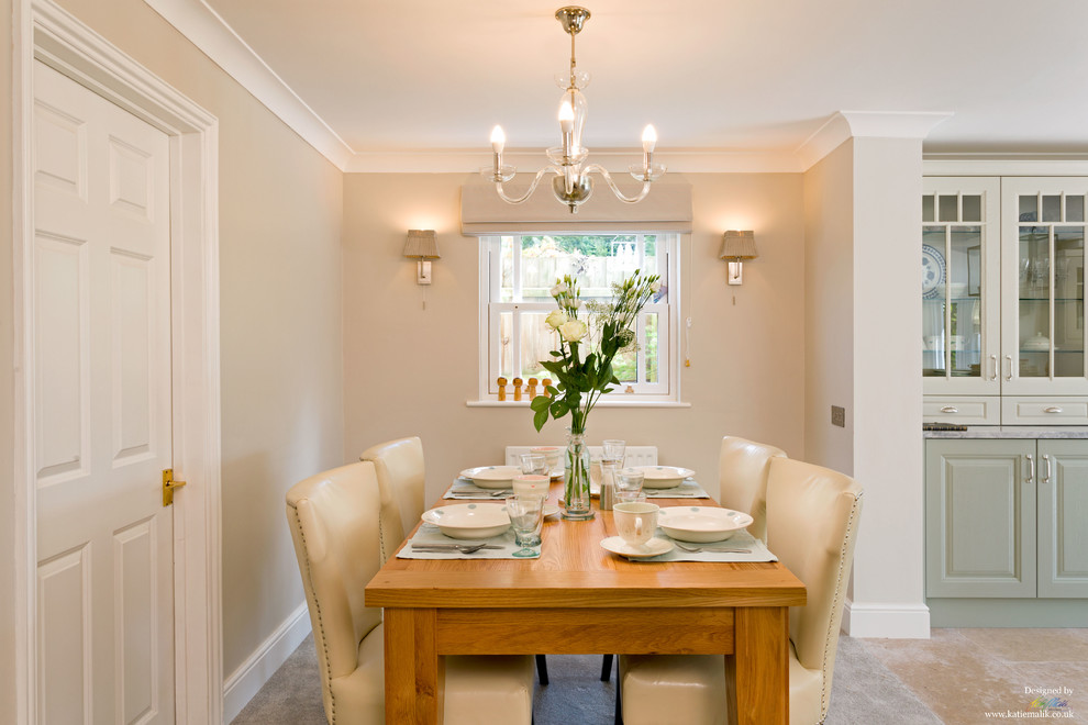 This is an example of a mid-sized transitional open plan dining in Cambridgeshire with grey walls, carpet and no fireplace.