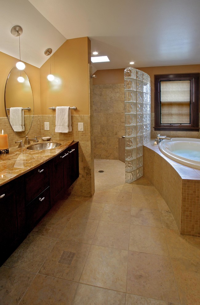 Inspiration for a large traditional master bathroom in Other with dark wood cabinets, shaker cabinets, a drop-in tub, an alcove shower, beige tile, an undermount sink, orange walls, stone tile, travertine floors, granite benchtops, a double vanity, a built-in vanity, brown floor, orange benchtops, a shower seat, decorative wall panelling and an open shower.