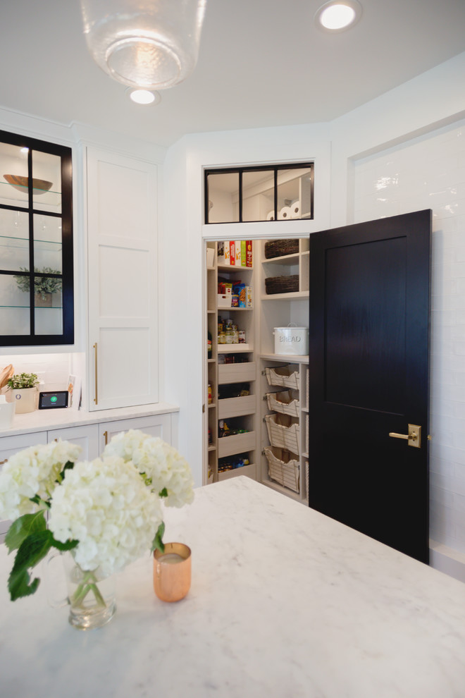 Inspiration for a small transitional l-shaped kitchen pantry in Minneapolis with flat-panel cabinets, light wood cabinets, laminate benchtops, light hardwood floors, with island, beige floor and beige benchtop.