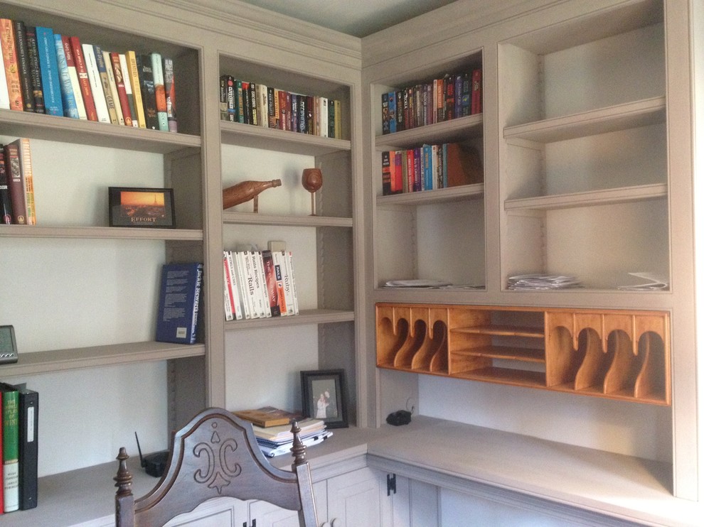 This is an example of a mid-sized traditional home office in Burlington with a library, white walls, dark hardwood floors and a freestanding desk.