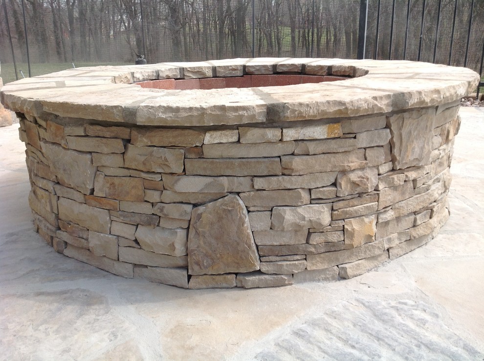 Mid-sized arts and crafts backyard patio in Kansas City with a fire feature and natural stone pavers.