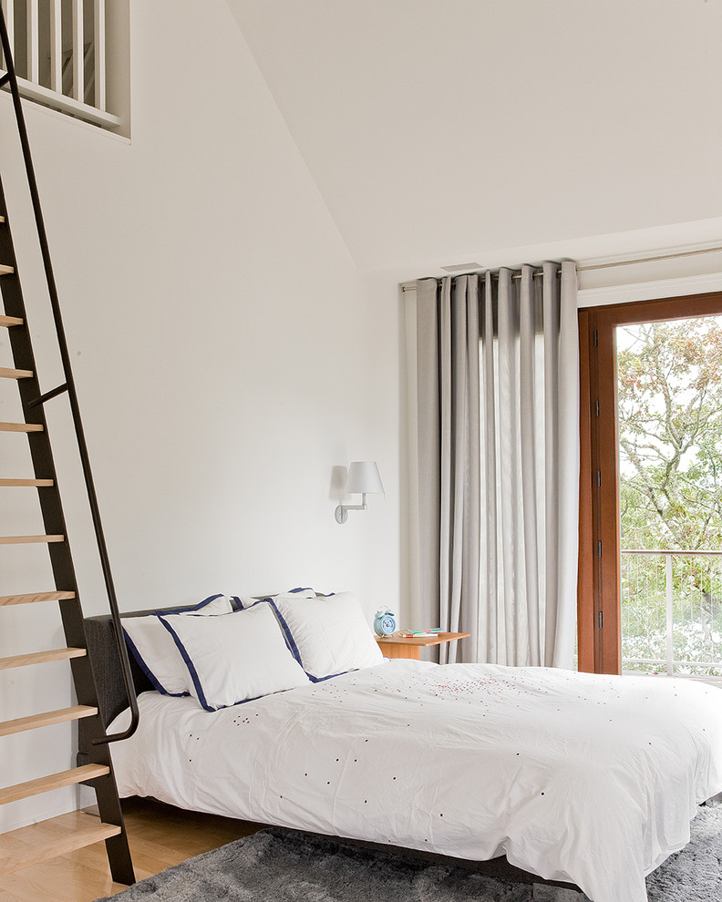Inspiration for a contemporary bedroom in Boston with white walls, light hardwood floors and no fireplace.