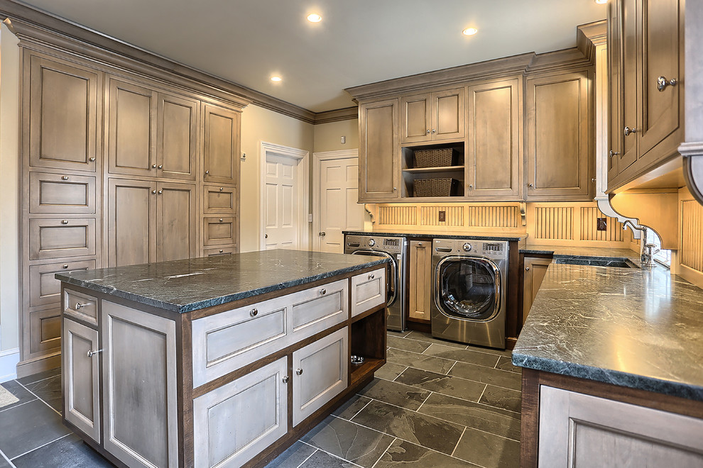 Design ideas for a large traditional l-shaped utility room in Other with a farmhouse sink, shaker cabinets, grey cabinets, beige walls, ceramic floors, a side-by-side washer and dryer and soapstone benchtops.