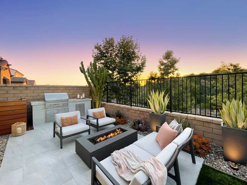 Example of a trendy backyard patio design in Orange County with no cover