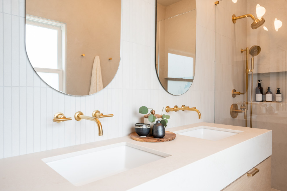 Inspiration för mellanstora minimalistiska beige en-suite badrum, med släta luckor, en dusch i en alkov, en vägghängd toalettstol, beige kakel, kakelplattor, beige väggar, klinkergolv i keramik, ett undermonterad handfat, bänkskiva i kvarts, beiget golv och dusch med gångjärnsdörr