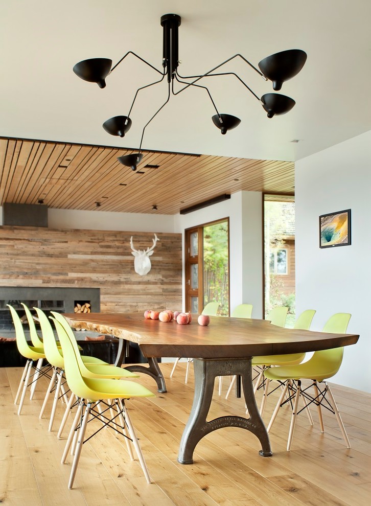 Country open plan dining in Other with white walls and light hardwood floors.
