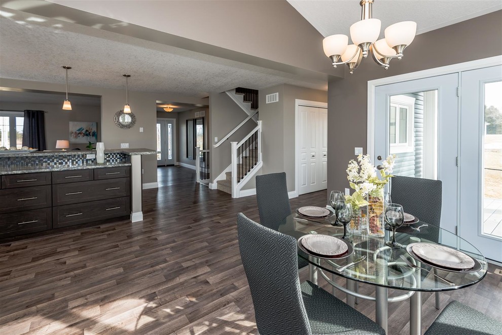 Large transitional medium tone wood floor and brown floor great room photo with brown walls and no fireplace