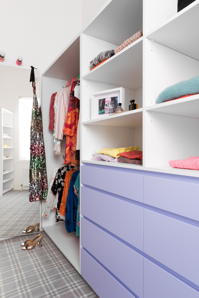 This is an example of a large eclectic gender-neutral walk-in wardrobe in Melbourne with flat-panel cabinets, carpet and grey floor.