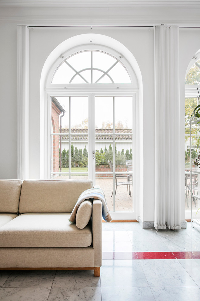 This is an example of a mid-sized traditional sunroom in Malmo with a standard ceiling and marble floors.