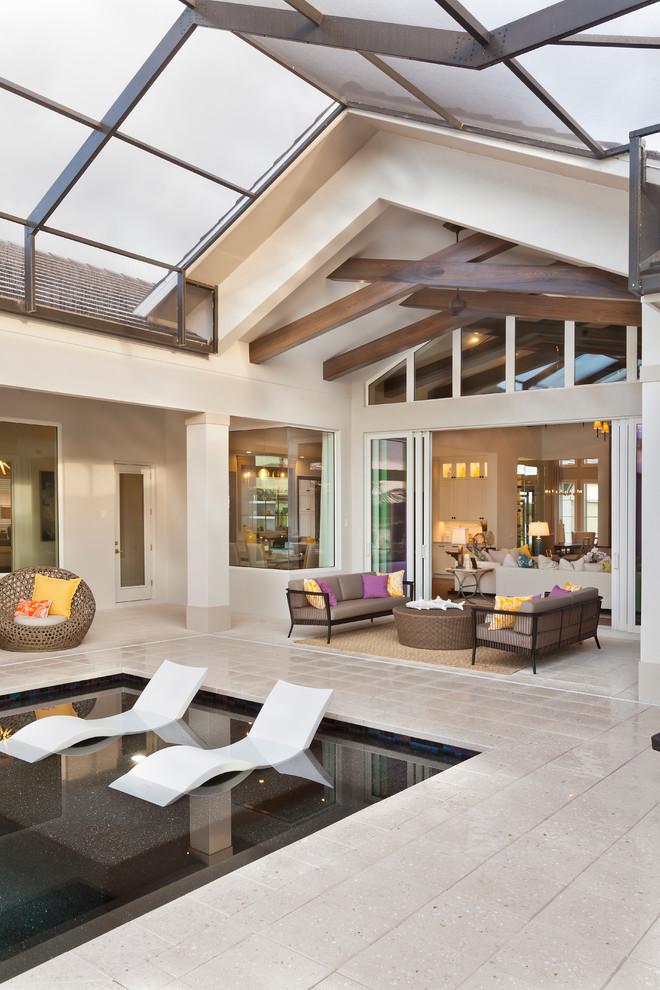 Patio - huge transitional backyard stone patio idea in Tampa with a roof extension