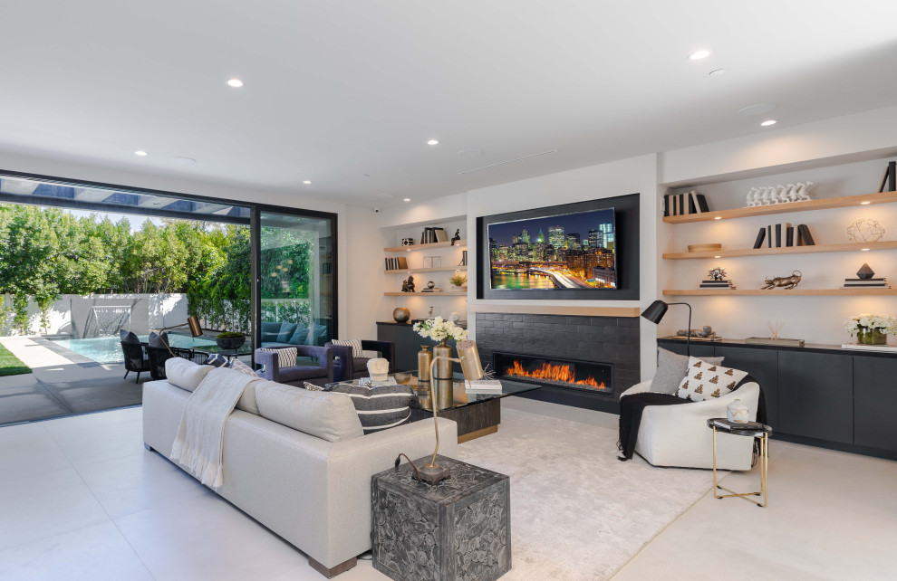 Design ideas for a large modern open plan living room in Los Angeles with white walls, porcelain flooring, a ribbon fireplace, a tiled fireplace surround, a wall mounted tv and grey floors.