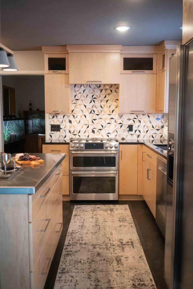 Photo of a large midcentury l-shaped eat-in kitchen in Other with a single-bowl sink, flat-panel cabinets, light wood cabinets, granite benchtops, multi-coloured splashback, marble splashback, stainless steel appliances, vinyl floors, with island, black floor and black benchtop.