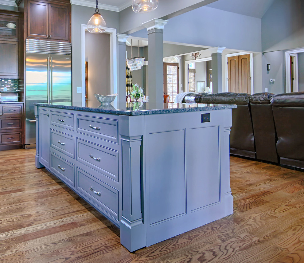 Example of a large transitional medium tone wood floor eat-in kitchen design in Charlotte with an undermount sink, flat-panel cabinets, stainless steel appliances and an island