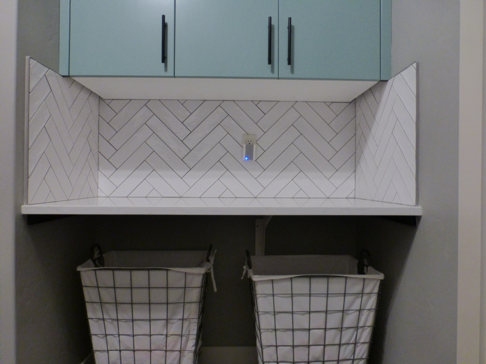 Photo of a mid-sized dedicated laundry room in Boise with turquoise cabinets, quartz benchtops, white splashback, ceramic splashback, a side-by-side washer and dryer and white benchtop.