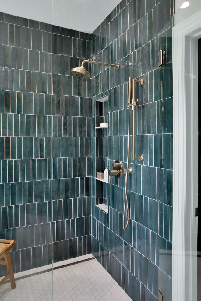This is an example of a large traditional ensuite bathroom in Denver with recessed-panel cabinets, grey cabinets, a freestanding bath, a walk-in shower, a one-piece toilet, green tiles, cement tiles, white walls, porcelain flooring, a submerged sink, engineered stone worktops, white floors, a hinged door, white worktops, a wall niche, double sinks and a built in vanity unit.