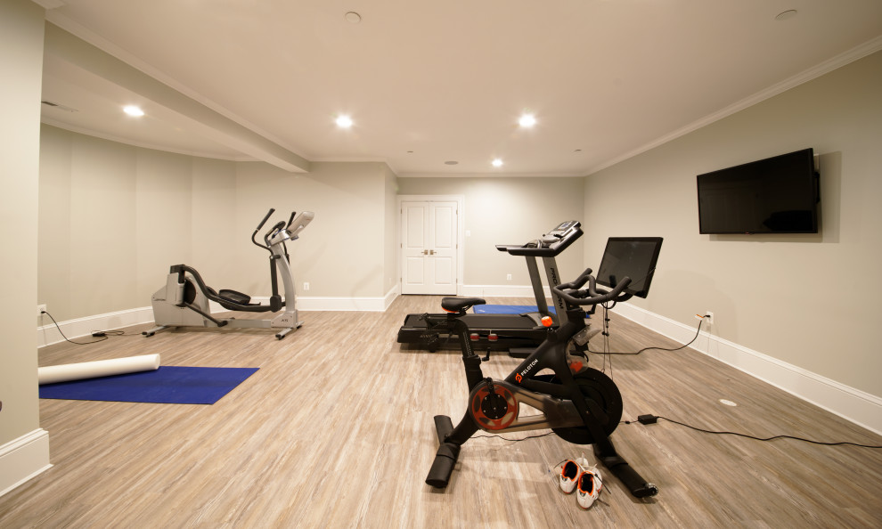 Photo of a large traditional multipurpose gym in DC Metro with beige walls, beige floor, laminate floors and coffered.