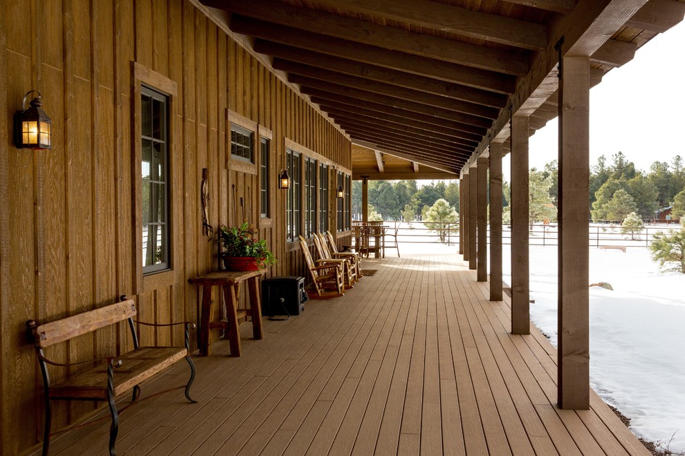 Inspiration for a mid-sized rustic front porch remodel in Phoenix with decking and a roof extension