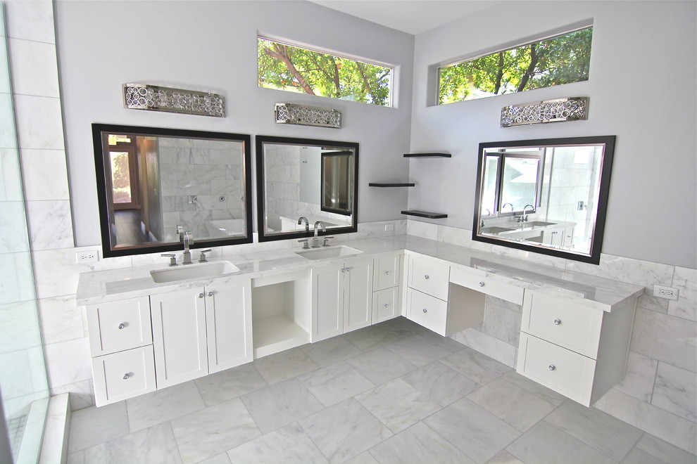 Inspiration for an expansive contemporary master bathroom in Las Vegas with shaker cabinets, white cabinets, gray tile, white tile, stone tile, granite benchtops, a freestanding tub, an alcove shower, grey walls, marble floors and an undermount sink.