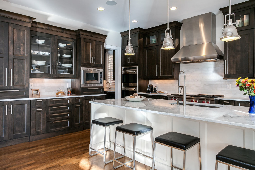 Example of a mid-sized transitional eat-in kitchen design in Miami with an undermount sink and stainless steel appliances