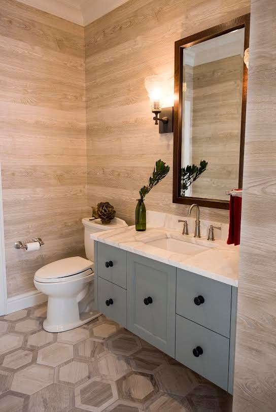 Inspiration for a large contemporary powder room in Other with flat-panel cabinets, grey cabinets, a two-piece toilet, beige tile, beige walls, a wall-mount sink, marble benchtops, beige floor and porcelain floors.