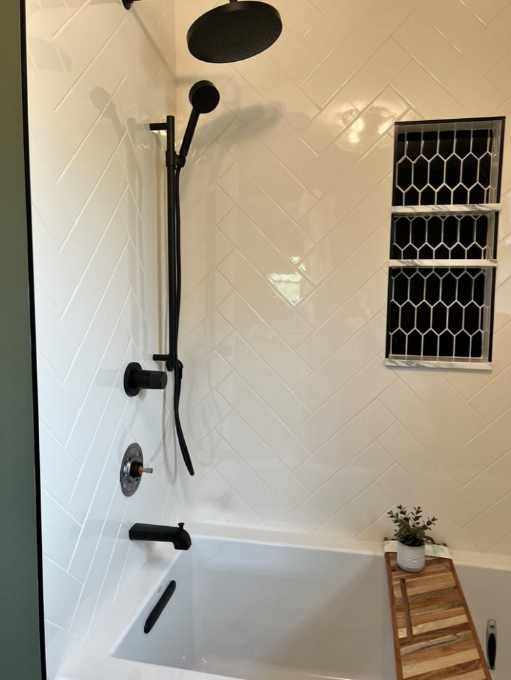 Inspiration for a mid-sized contemporary master bathroom in Chicago with recessed-panel cabinets, brown cabinets, a drop-in tub, a shower/bathtub combo, a one-piece toilet, green tile, ceramic tile, green walls, porcelain floors, an undermount sink, marble benchtops, black floor, a sliding shower screen, a niche, a double vanity and a built-in vanity.