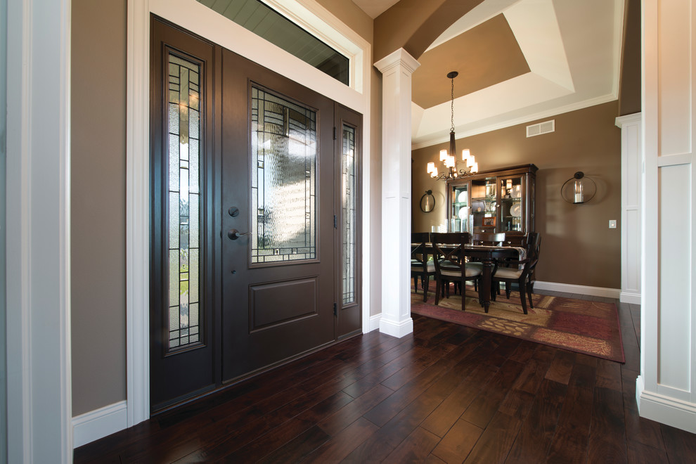 Example of a large transitional dark wood floor and brown floor front door design in Boston with brown walls and a dark wood front door