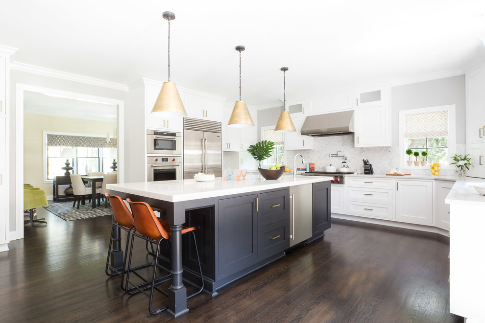 Transitional separate kitchen in New York with shaker cabinets, white cabinets, white splashback, stainless steel appliances, dark hardwood floors, with island and brown floor.