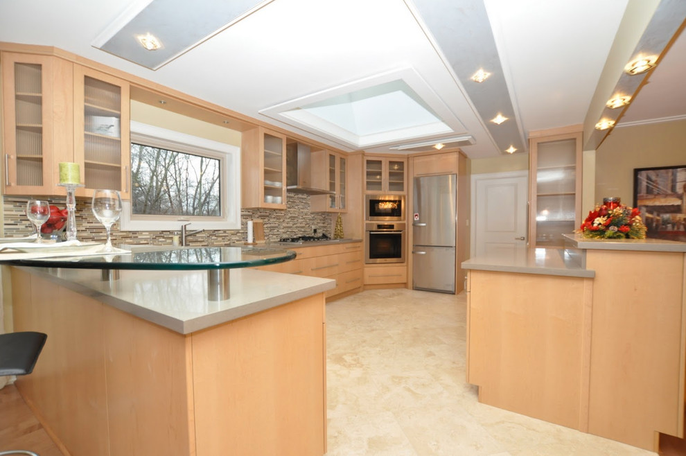 Photo of a large contemporary u-shaped separate kitchen in Toronto with an undermount sink, flat-panel cabinets, light wood cabinets, quartz benchtops, beige splashback, mosaic tile splashback, stainless steel appliances, travertine floors and a peninsula.