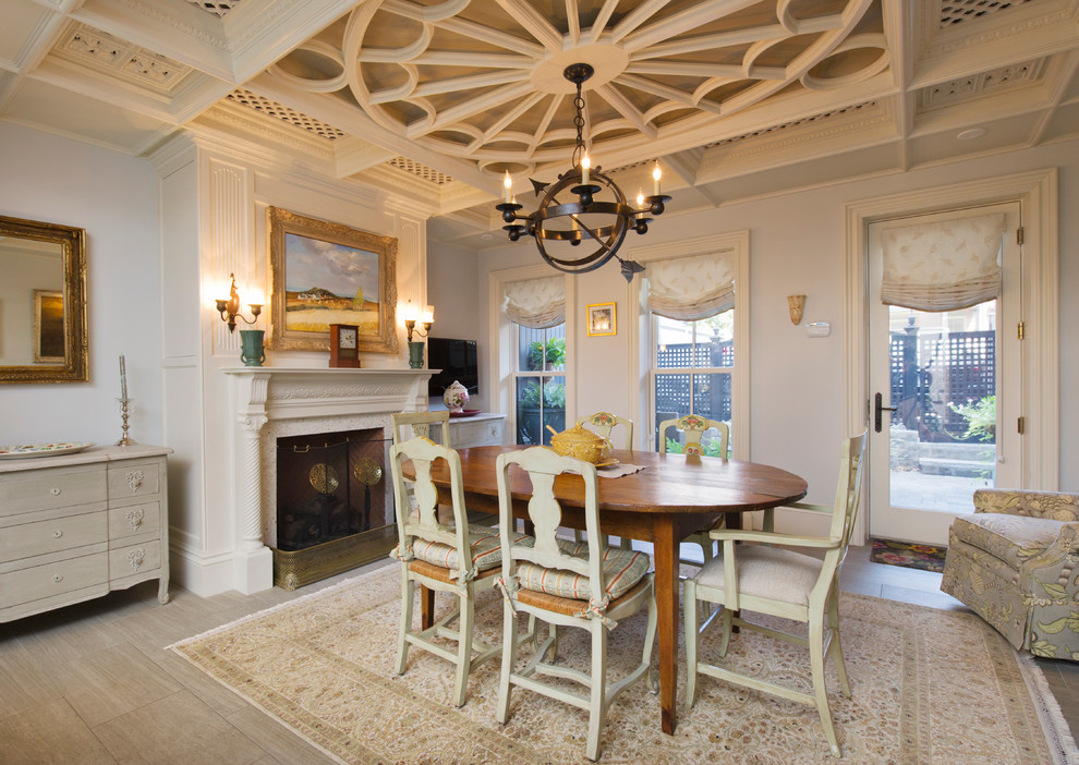Traditional dining room in Boston with grey walls and a standard fireplace.
