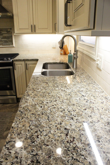 Beige Kitchen With Extra Large Island Tile Backsplash And Granite