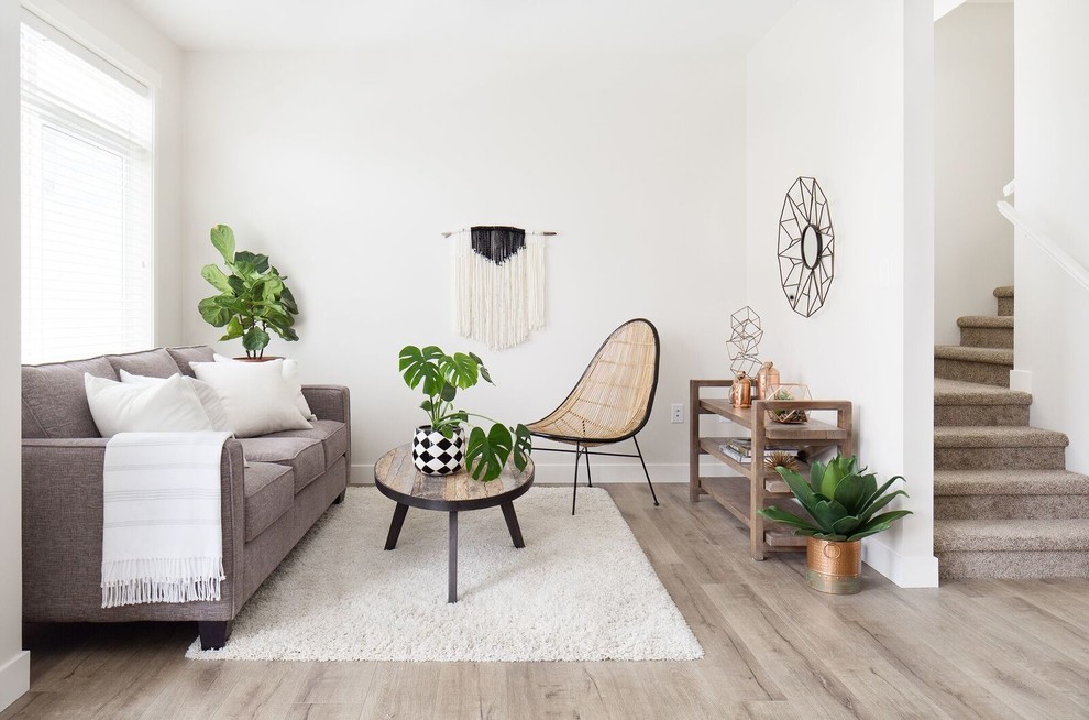 Photo of a scandinavian formal enclosed living room in Vancouver with white walls, light hardwood floors, no fireplace, no tv and beige floor.
