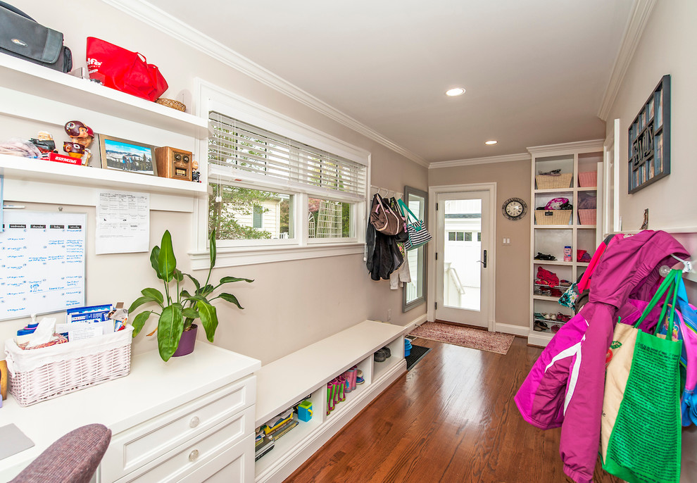 Large transitional medium tone wood floor mudroom photo in DC Metro