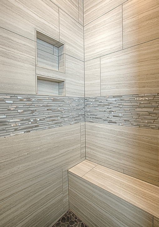 Photo of a modern bathroom in Austin with a corner shower, gray tile and pebble tile.