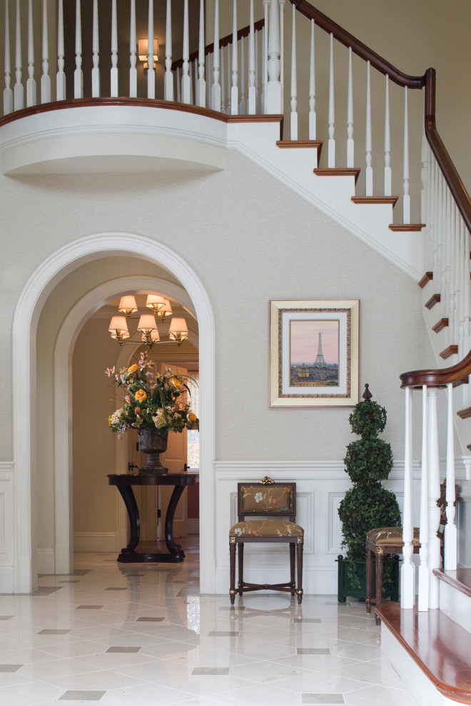 Design ideas for an expansive transitional foyer in Boston with beige walls, marble floors, a single front door and a dark wood front door.