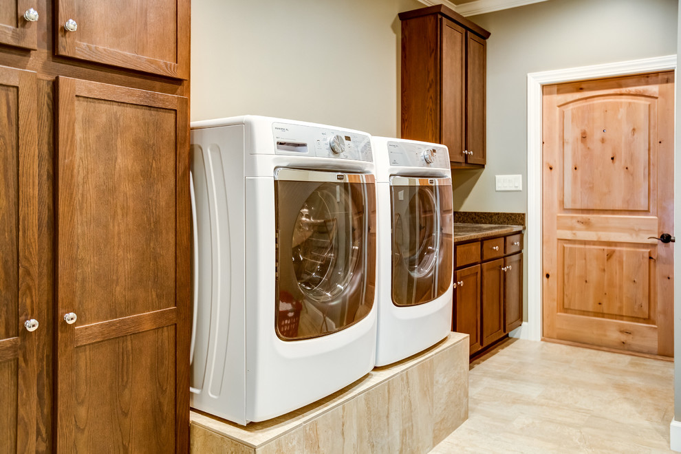 Inspiration for a mid-sized contemporary single-wall dedicated laundry room in Birmingham with an undermount sink, shaker cabinets, dark wood cabinets, granite benchtops, grey walls, ceramic floors and a side-by-side washer and dryer.