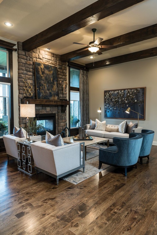 Large transitional open concept family room in Kansas City with beige walls, a two-sided fireplace, a stone fireplace surround, a home bar, dark hardwood floors, no tv and brown floor.